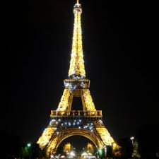 Illuminated Eiffel Tower in Paris at night.